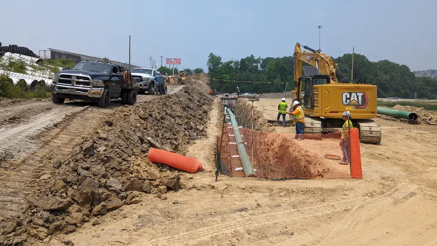 Casing pipe being placed in an excavation at a road crossing