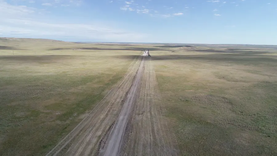 Aerial view of a cross-country pipeline right-of-way running to the horizon