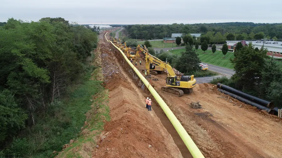 Aerial view of pipe strung along the right-of-way with graded ground on both sides