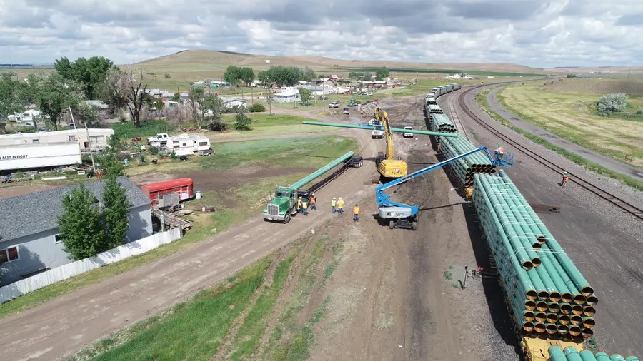 Aerial view of coated pipe strung along a pipeline right-of-way