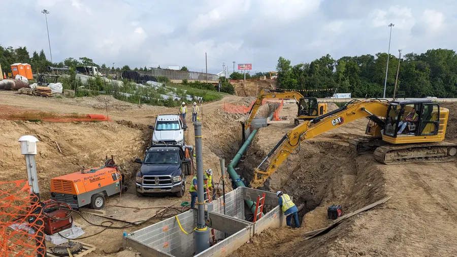 Crews working a shored pipeline trench