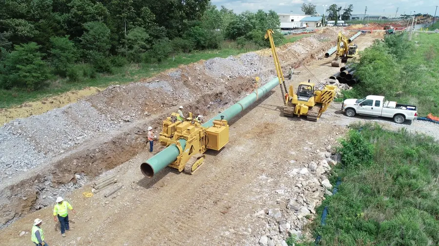 Aerial view of a pipeline being safely lowered into the trench