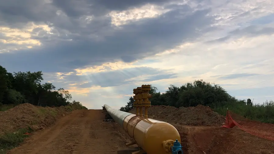 A pipe assembly set on the pipeline right-of-way at dusk